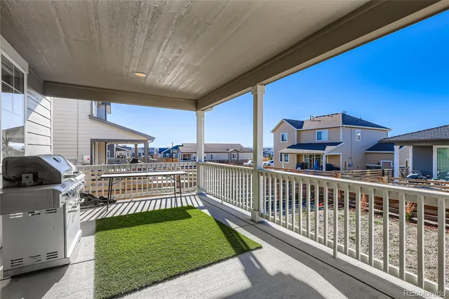 a view of a house with wooden floor next to a yard