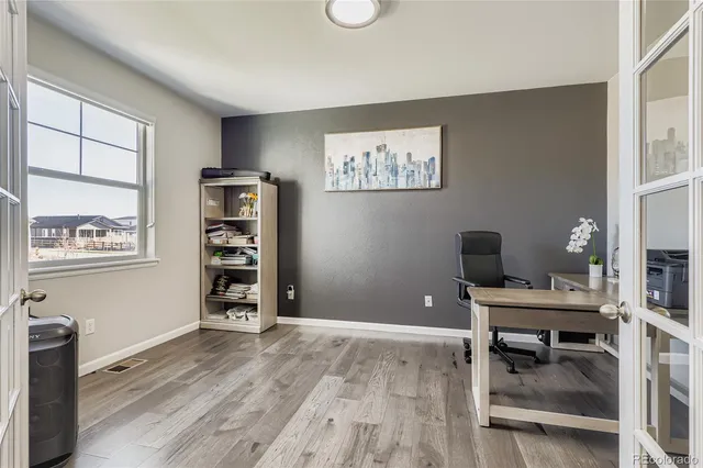 a view of a workspace with furniture and a window