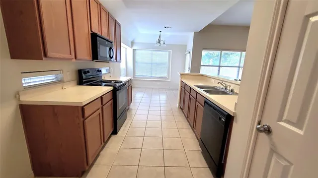 a kitchen with a sink stove and cabinets