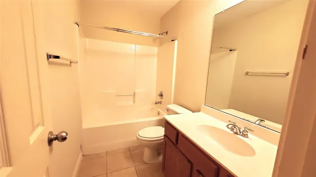 a bathroom with a sink a toilet a mirror and shower