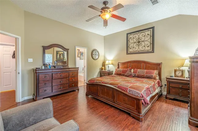 a bedroom with a bed and a dresser in it