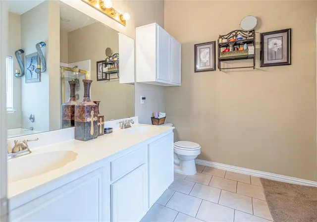a bathroom with a sink mirror and toilet