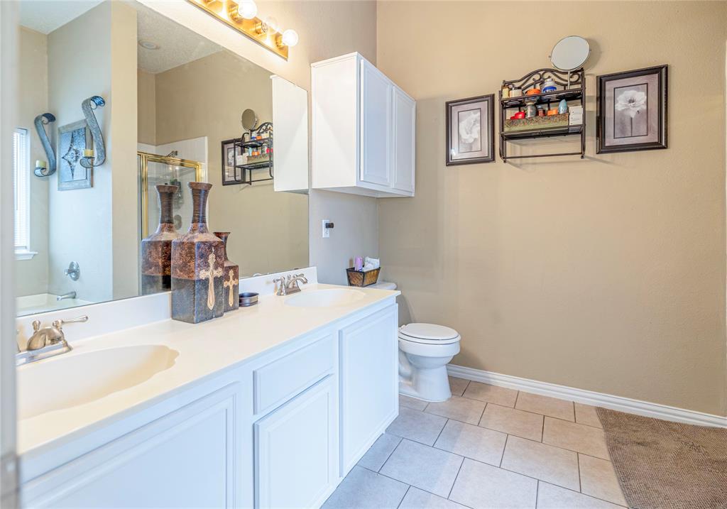 3103 Scott Drive Sachse, TX 75048 - Photo 16 of 26 a bathroom with a sink mirror and toilet