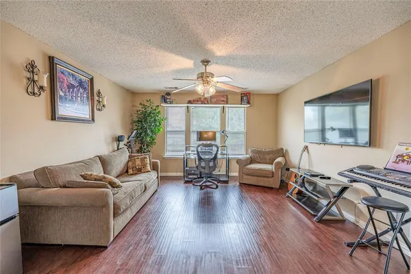 a living room with furniture and a wooden floor