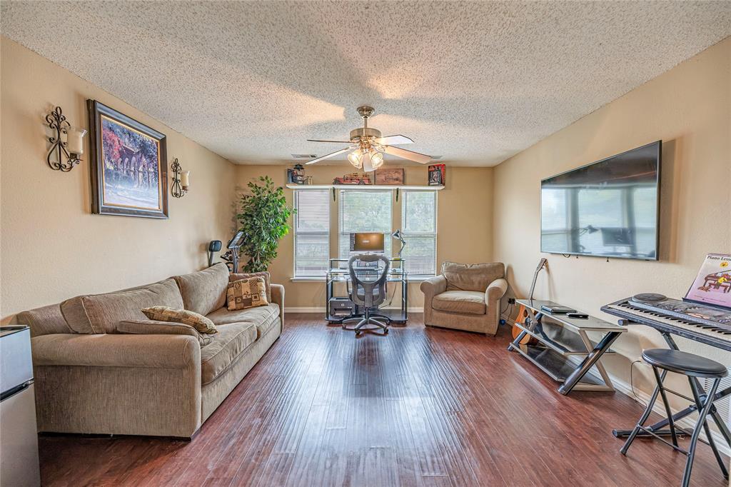 3103 Scott Drive Sachse, TX 75048 - Photo 17 of 26 a living room with furniture and a wooden floor