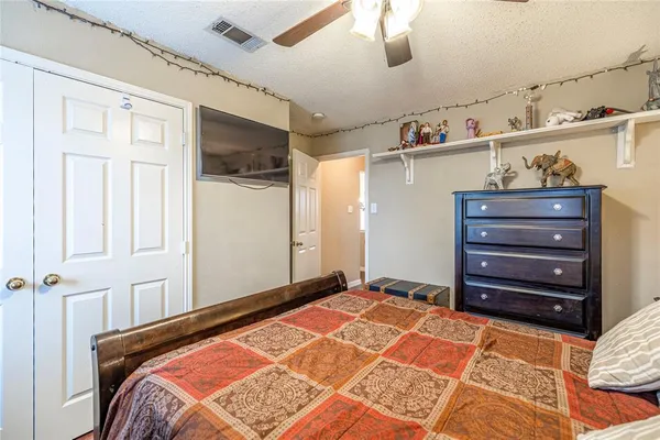 a bedroom with a bed and cabinets