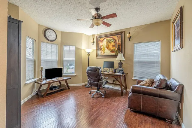 a view of a livingroom with workspace and a window