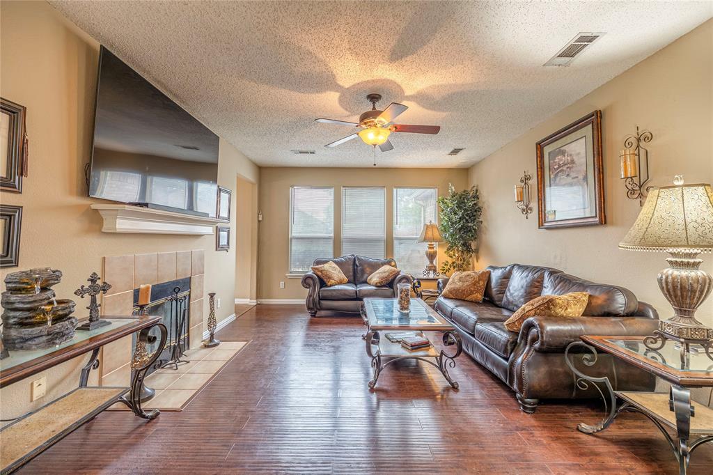 3103 Scott Drive Sachse, TX 75048 - Photo 6 of 26 a living room with furniture fireplace and a large window