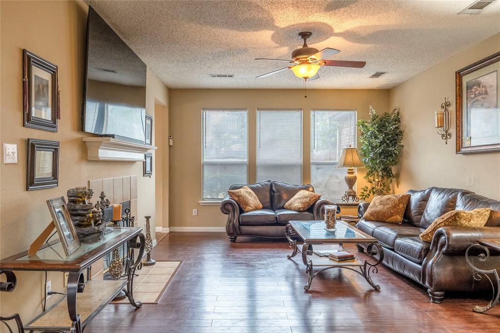 3103 Scott Drive Sachse, TX 75048 - Photo 7 of 26 a living room with furniture and a chandelier