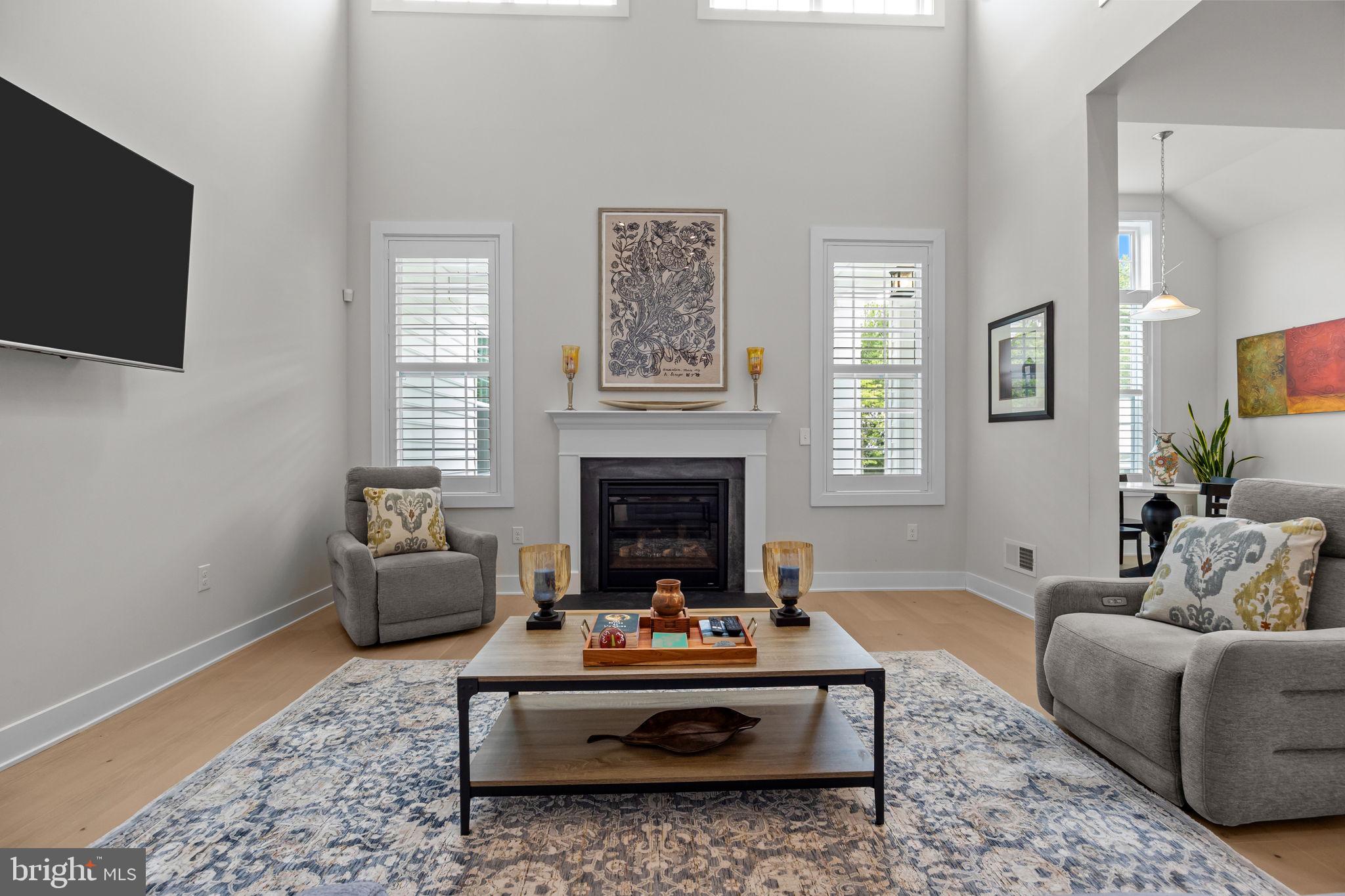 164 Tyler Way Yardley, PA 19067 - Photo 5 of 34 a living room with furniture a flat screen tv and a fireplace