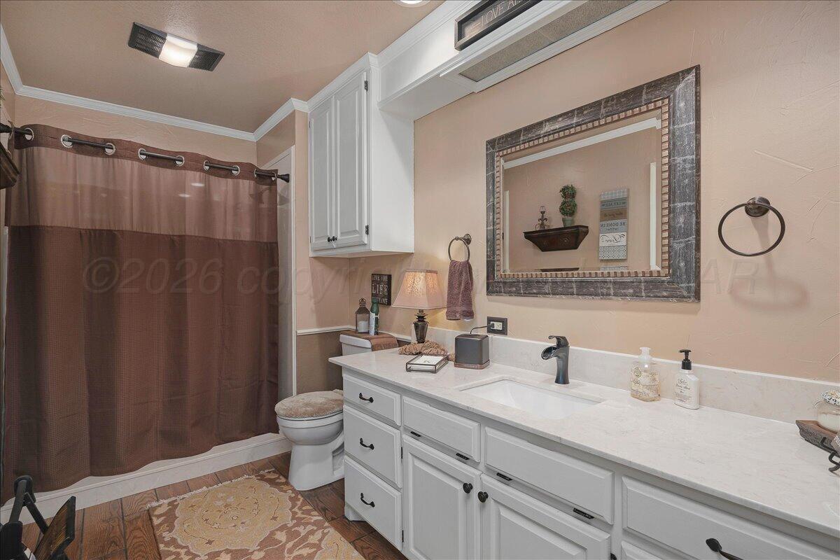 5 Locke Place Amarillo, TX 79124 - Photo 24 of 53 a bathroom with a granite countertop sink a toilet and a mirror