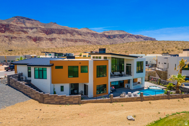 3606 South Cypress Road Hurricane, UT 84737 - Photo 3 of 69 Back of house with a patio area, stucco siding, a fenced backyard, a mountain view, and a standing seam roof