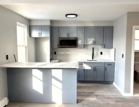 a kitchen with a sink stove and cabinets