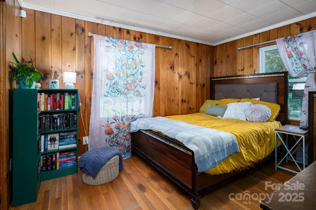 a bedroom with a bed and a book shelf