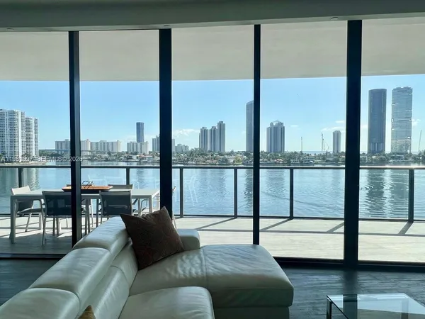 a living room with couch and a floor to ceiling window