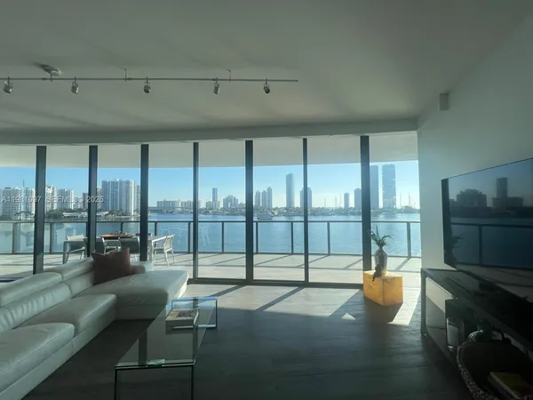 a kitchen with granite countertop a sink and a refrigerator