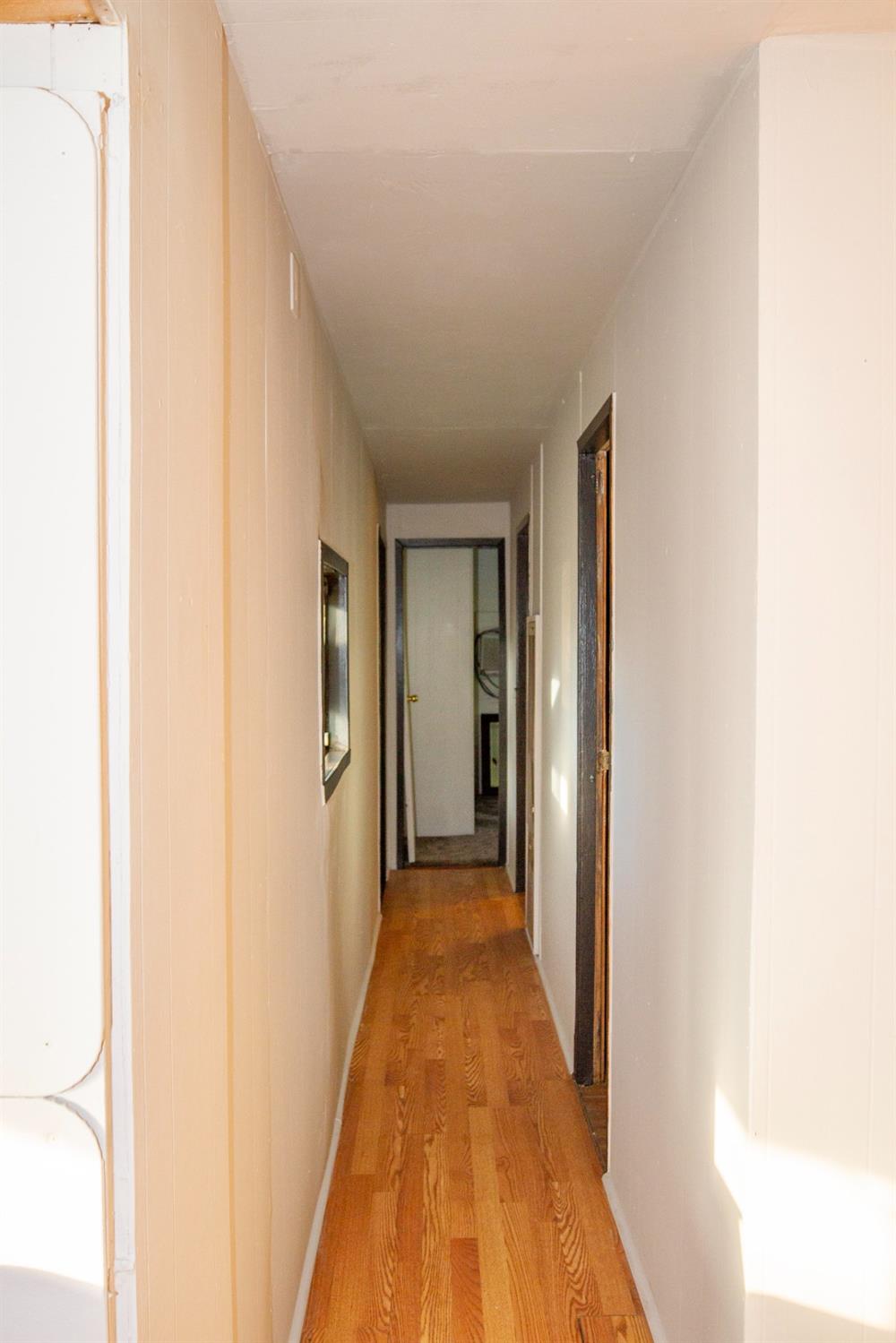 39428 Squaw Valley Road Squaw Valley, CA 93675 - Photo 4 of 14 a view of a hallway with wooden floor