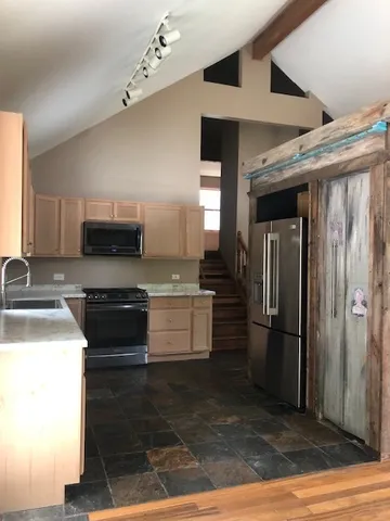 a kitchen with a refrigerator and a sink