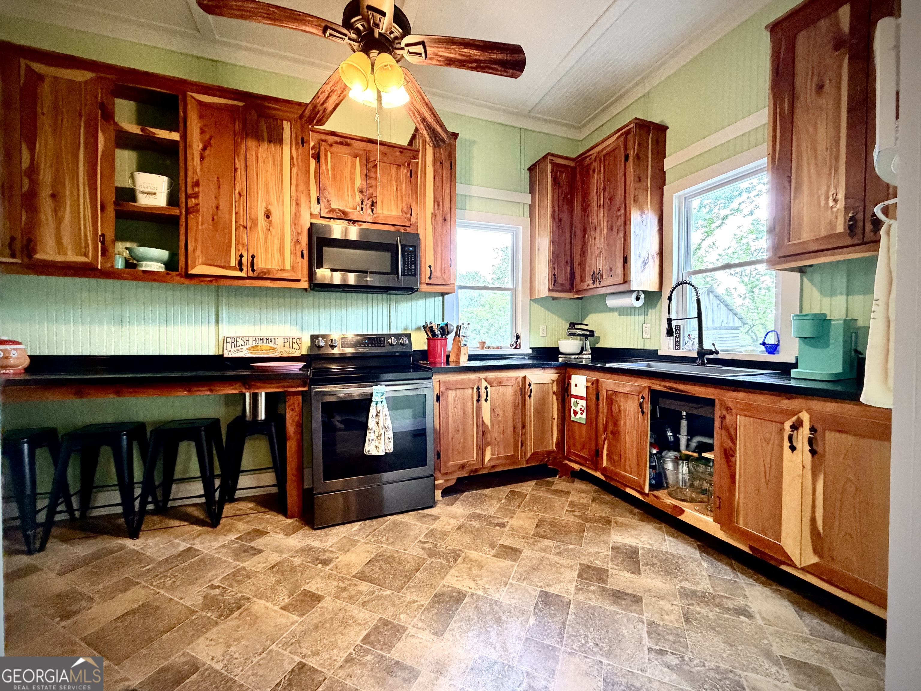 629 Bobby Fortner Road Kite, GA 31049 - Photo 14 of 63 a kitchen with stainless steel appliances granite countertop a stove a sink and a microwave
