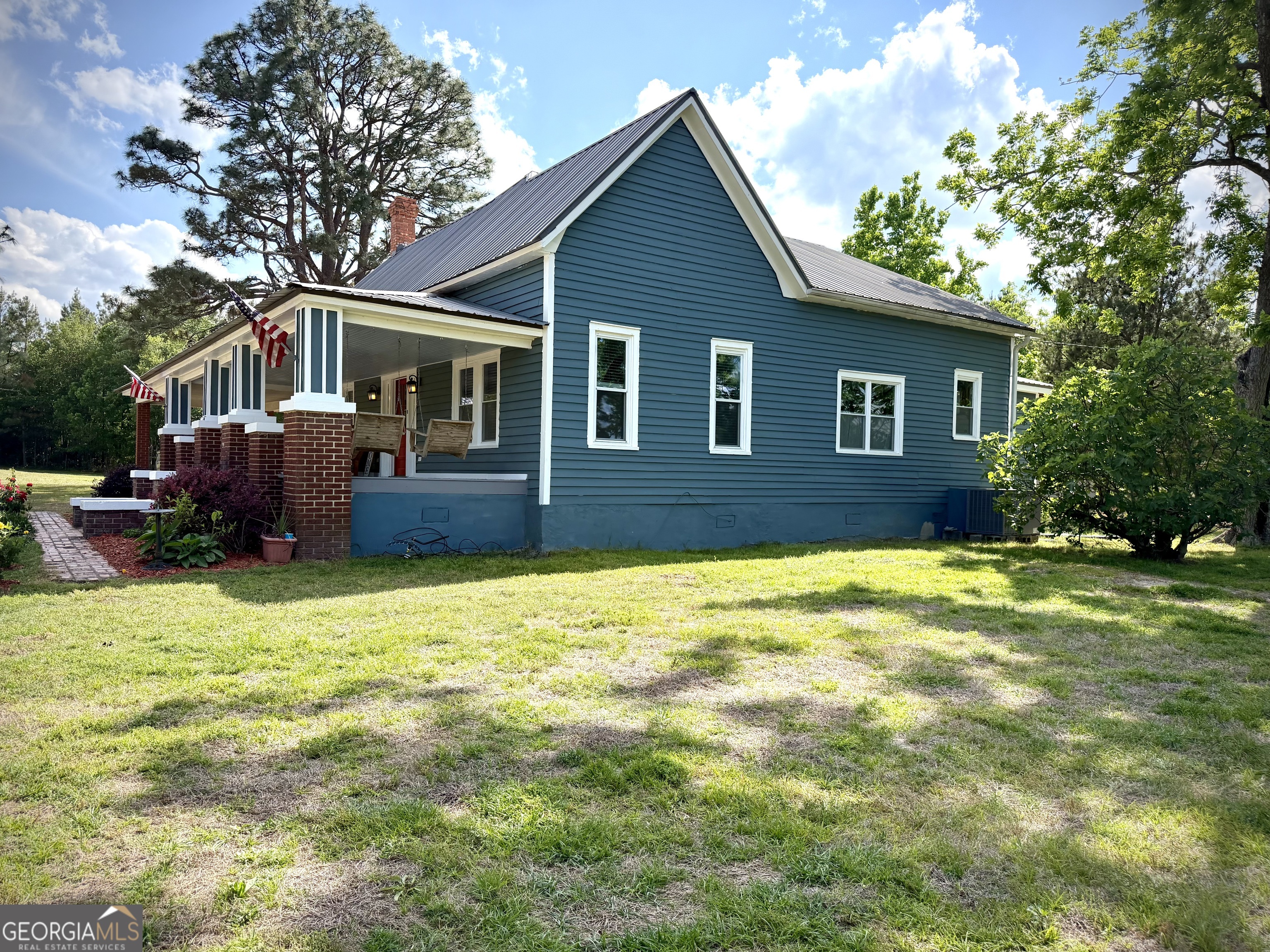 629 Bobby Fortner Road Kite, GA 31049 - Photo 2 of 63 a front view of a house with a garden
