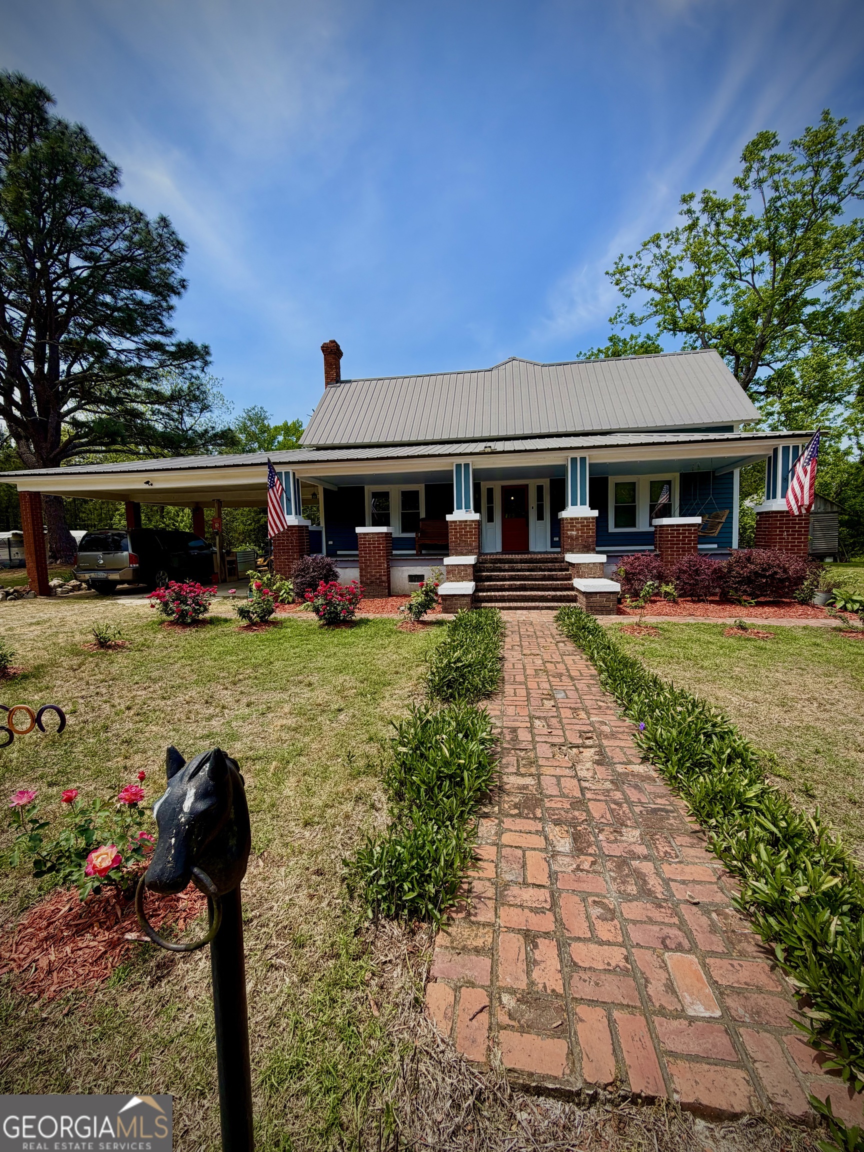 629 Bobby Fortner Road Kite, GA 31049 - Photo 44 of 63 a front view of a house with garden and trees