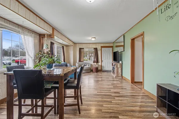 a view of a dining room with furniture and a potted plant