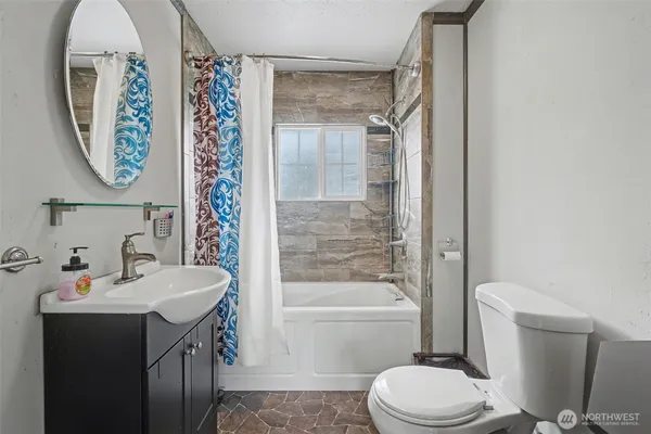 a bathroom with a toilet a sink and a bathtub