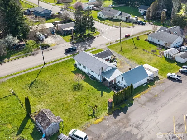 an aerial view of a house with swimming pool and outdoor seating