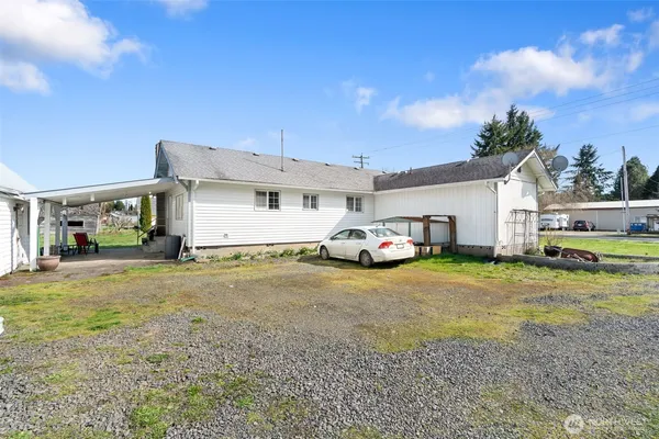 a front view of a house with a garden and yard