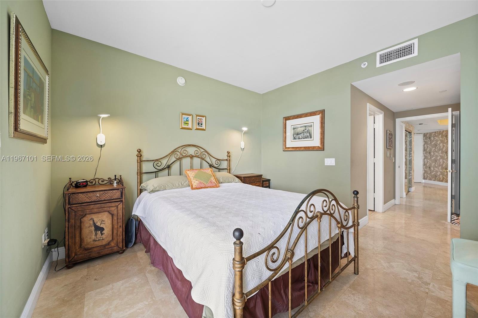 4775 Collins Avenue, Unit 1203 Miami Beach, FL 33140 - Photo 23 of 43 a bedroom with a bed and a chandelier