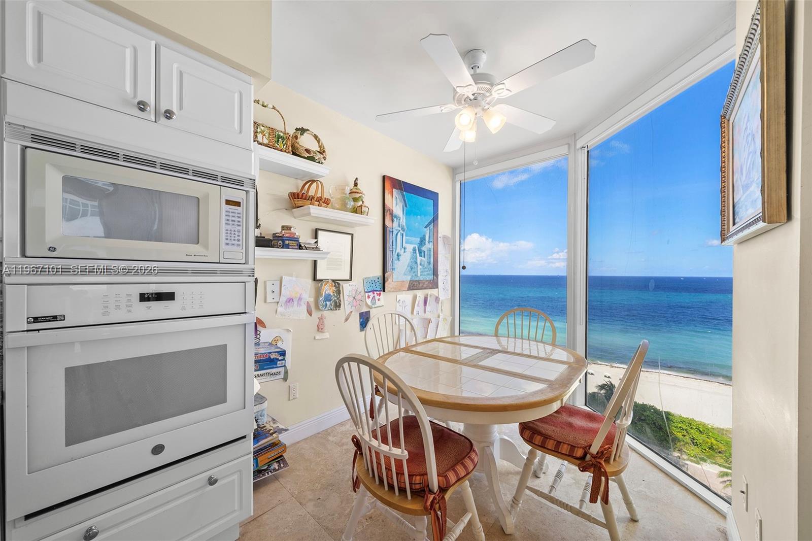 4775 Collins Avenue, Unit 1203 Miami Beach, FL 33140 - Photo 7 of 43 a kitchen with stainless steel appliances kitchen island granite countertop furniture and a fireplace
