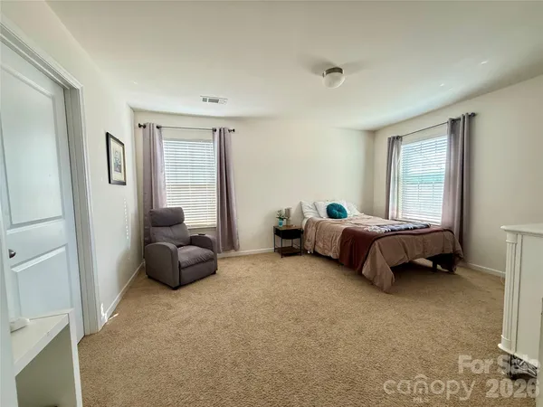 a bedroom with furniture and a window