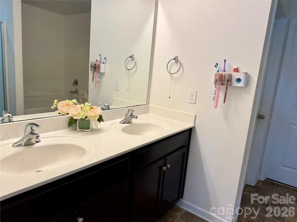 a bathroom with a double vanity sink and mirror