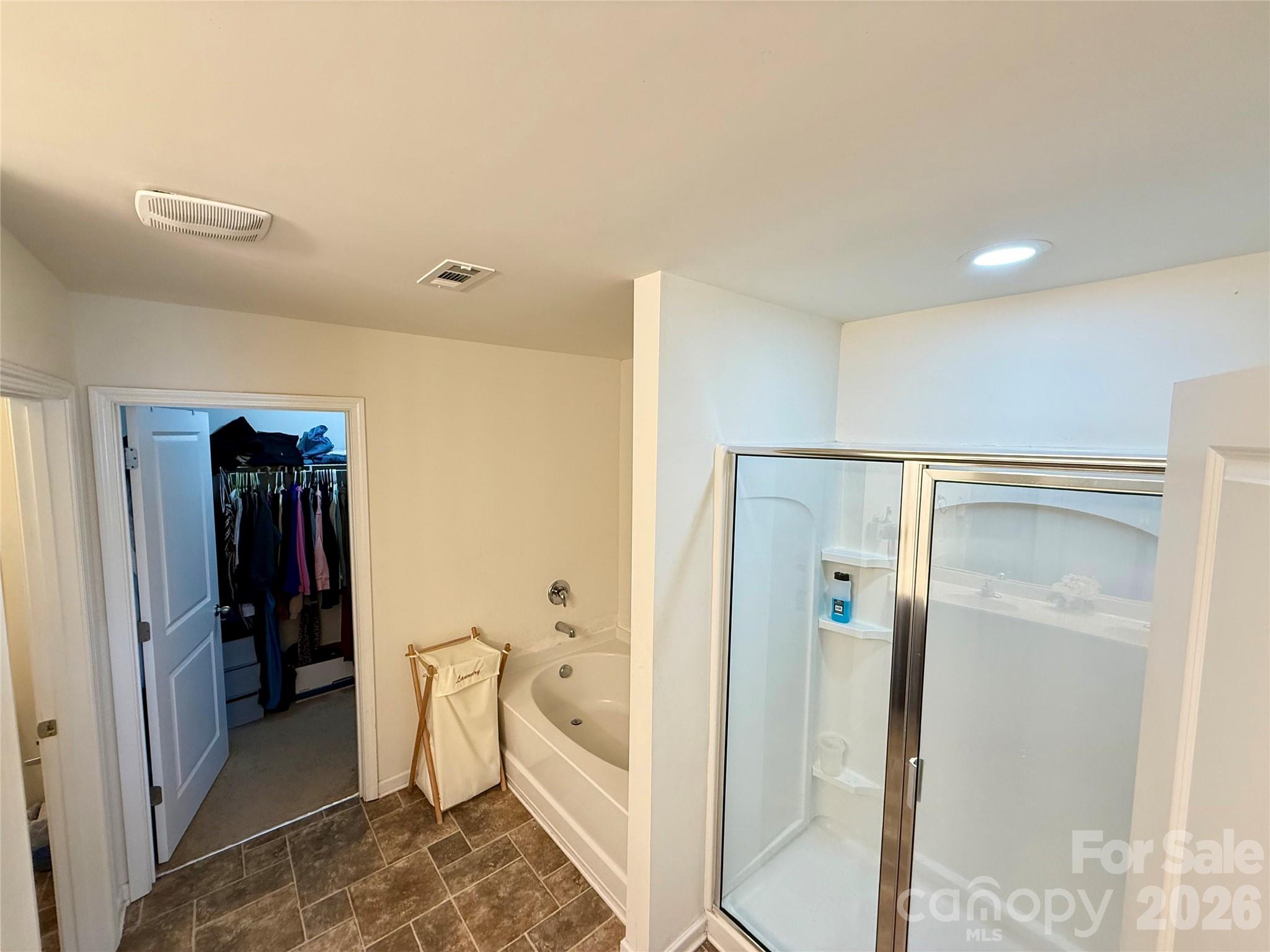 4018 BETHESDA Place Concord, NC 28025 - Photo 17 of 21 a bathroom with a bathtub and a toilet