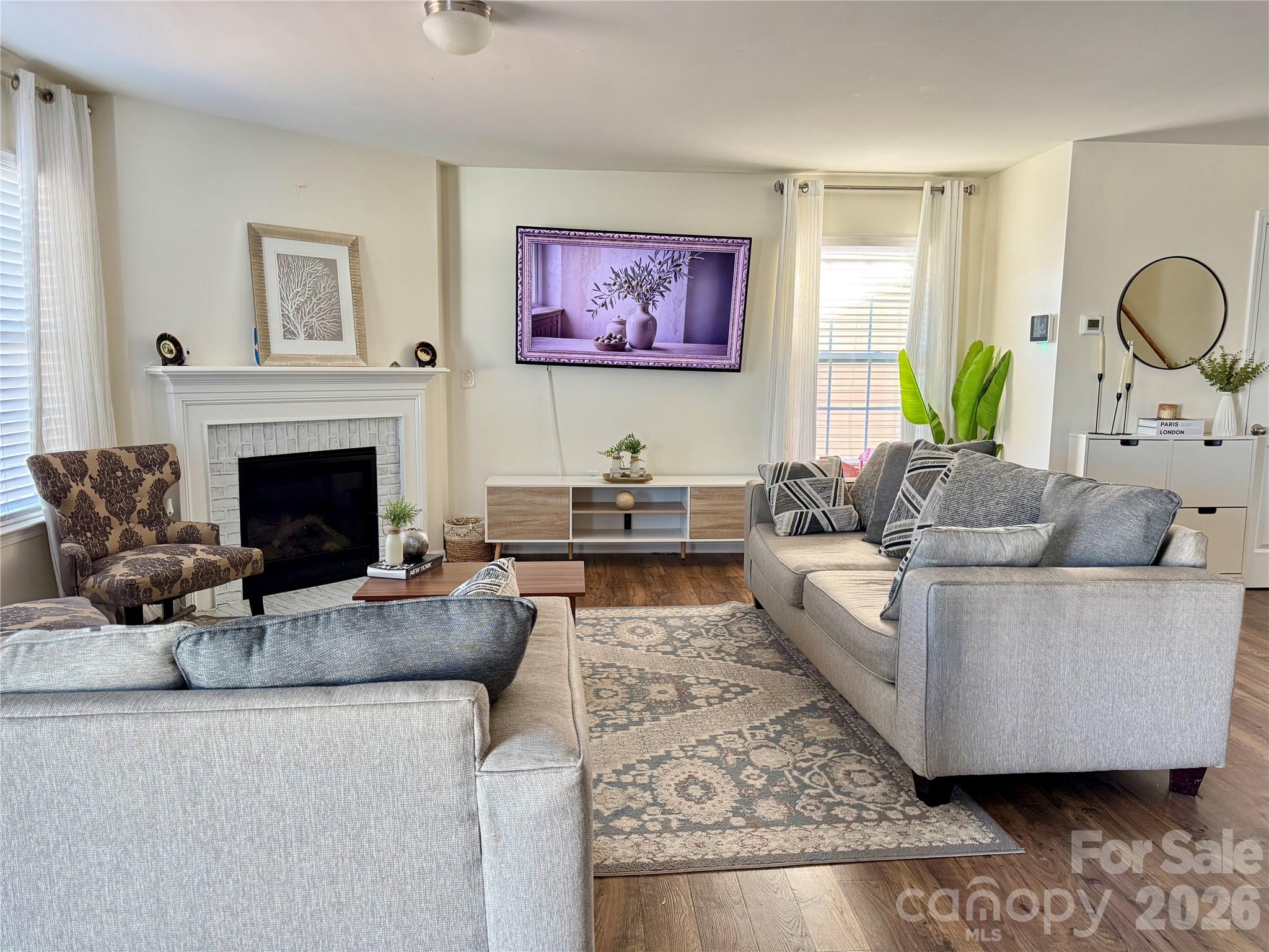 4018 BETHESDA Place Concord, NC 28025 - Photo 3 of 21 a living room with furniture a fireplace and a large mirror