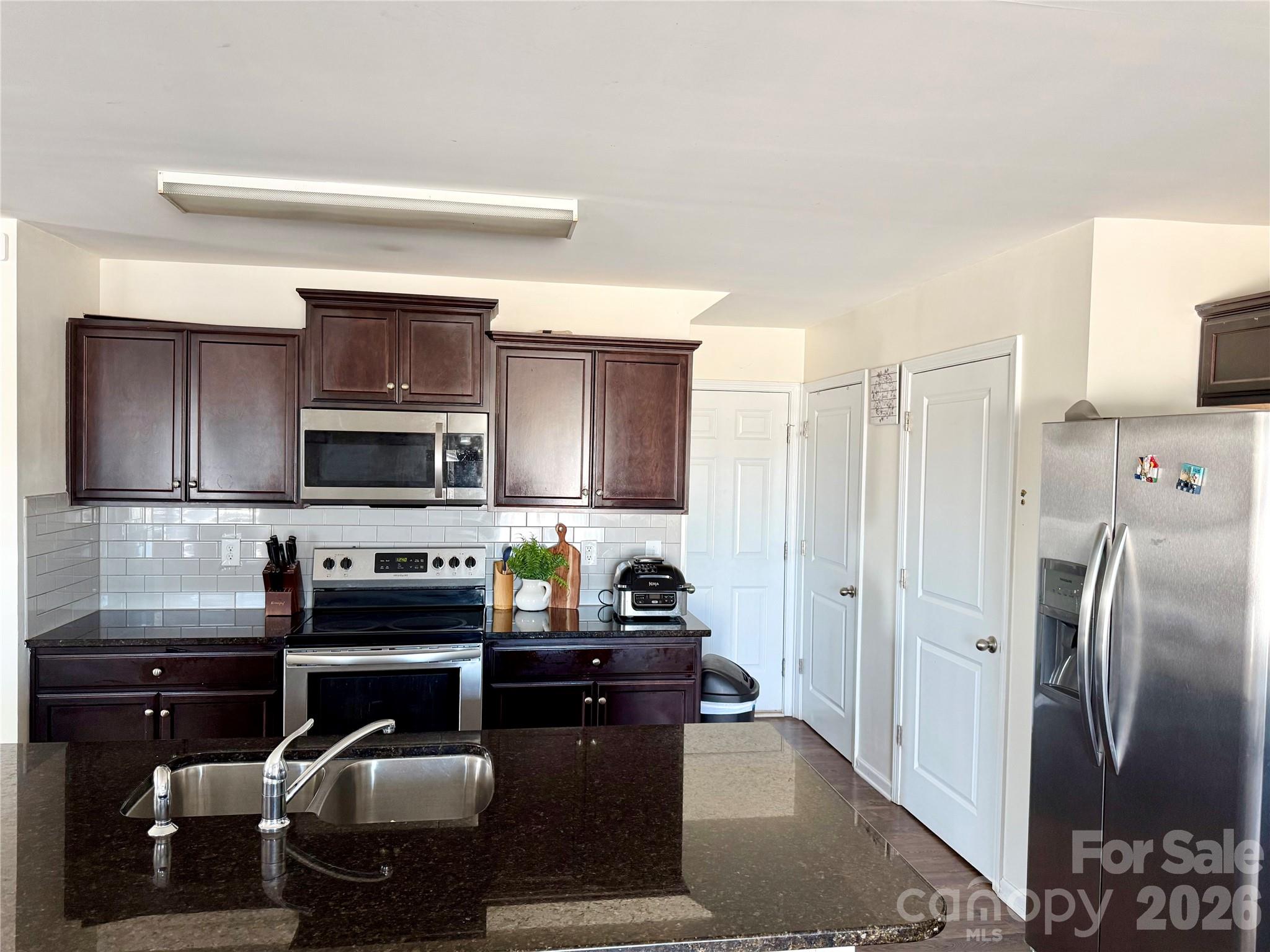 4018 BETHESDA Place Concord, NC 28025 - Photo 6 of 21 a kitchen with stainless steel appliances granite countertop a refrigerator and a stove