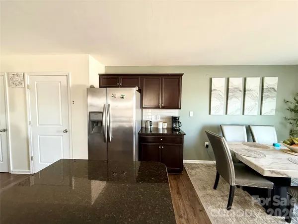 a kitchen with refrigerator cabinets and wooden floor