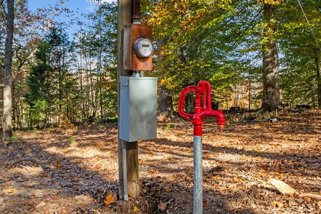 a street sign on a sidewalk next to a road