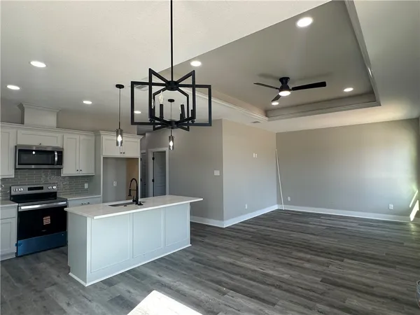 a view of a kitchen with a sink and microwave