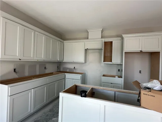 a kitchen that has a sink and a stove in it