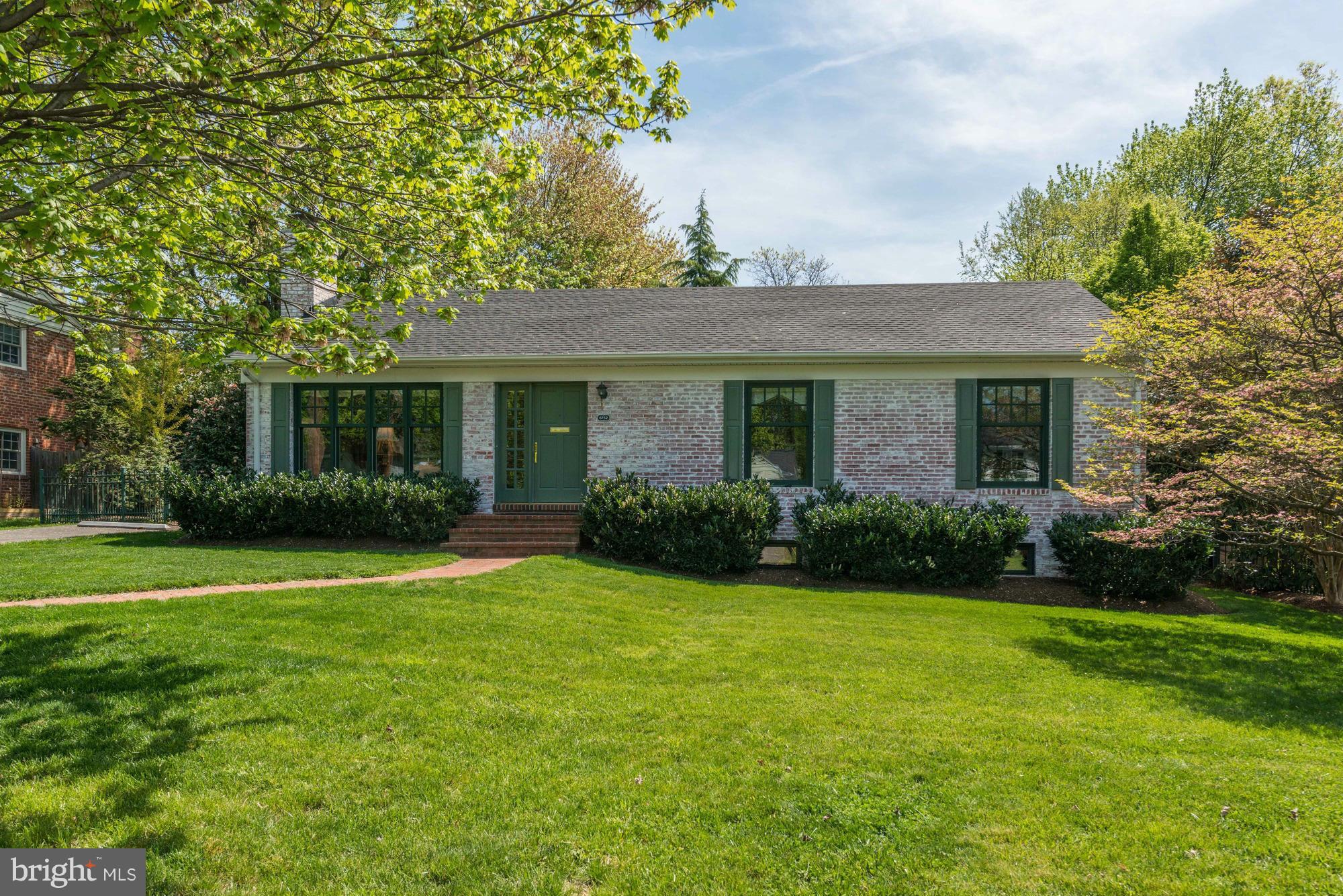 6752 Little Falls Road Arlington, VA 22213 - Photo 1 of 30 a front view of a house with a yard and green space