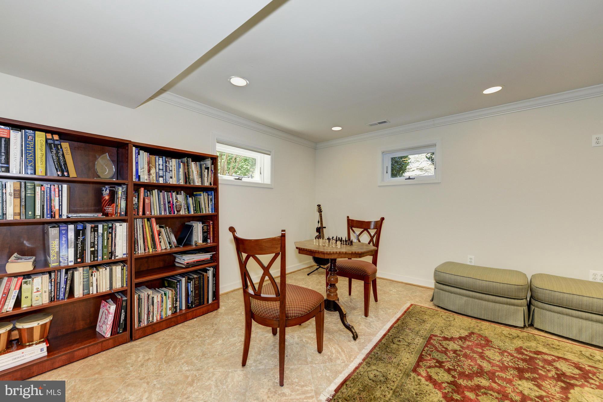 6752 Little Falls Road Arlington, VA 22213 - Photo 23 of 30 a bedroom with furniture and a book shelf