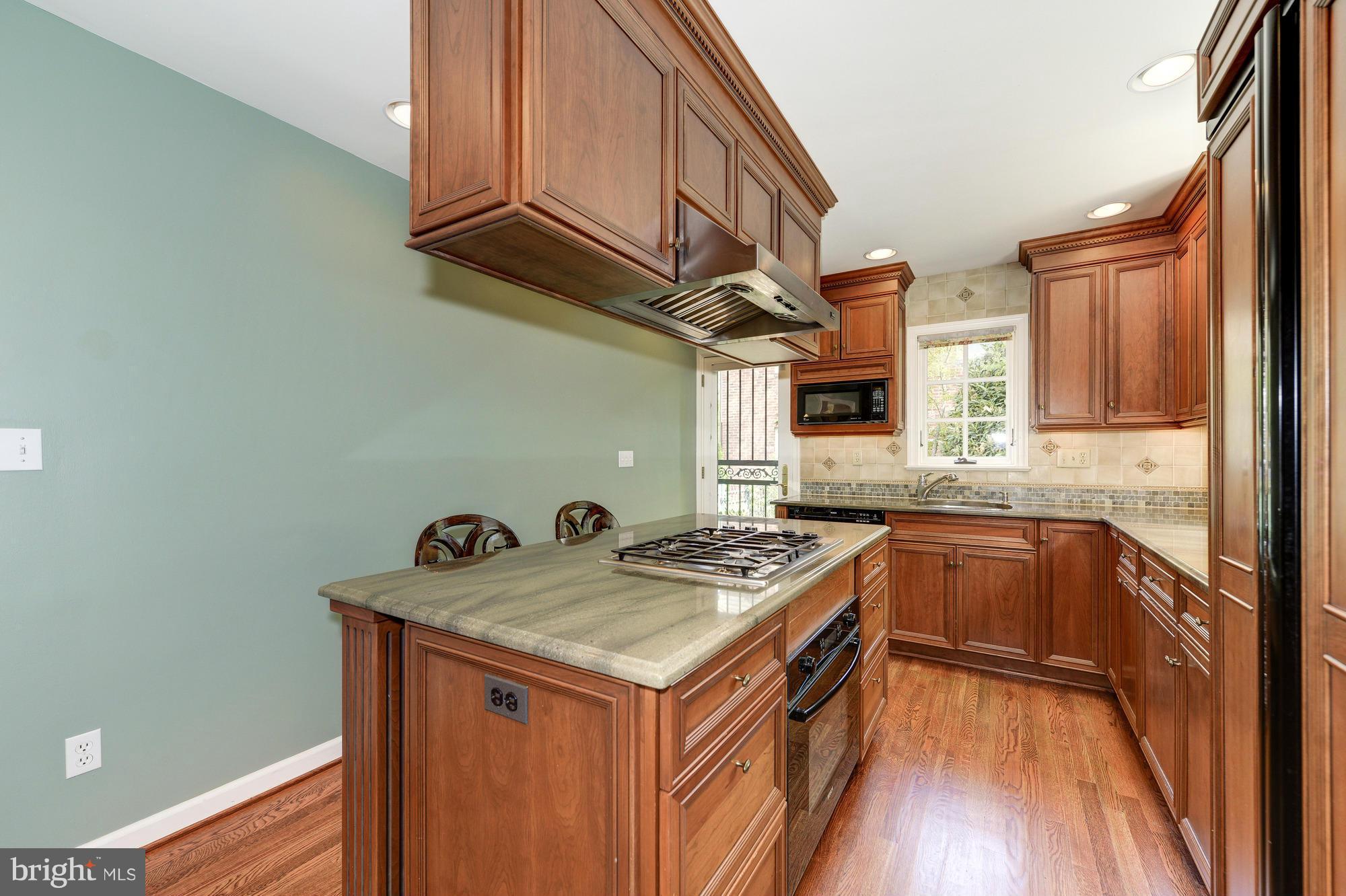6752 Little Falls Road Arlington, VA 22213 - Photo 5 of 30 a kitchen with stainless steel appliances granite countertop a stove a sink and a refrigerator