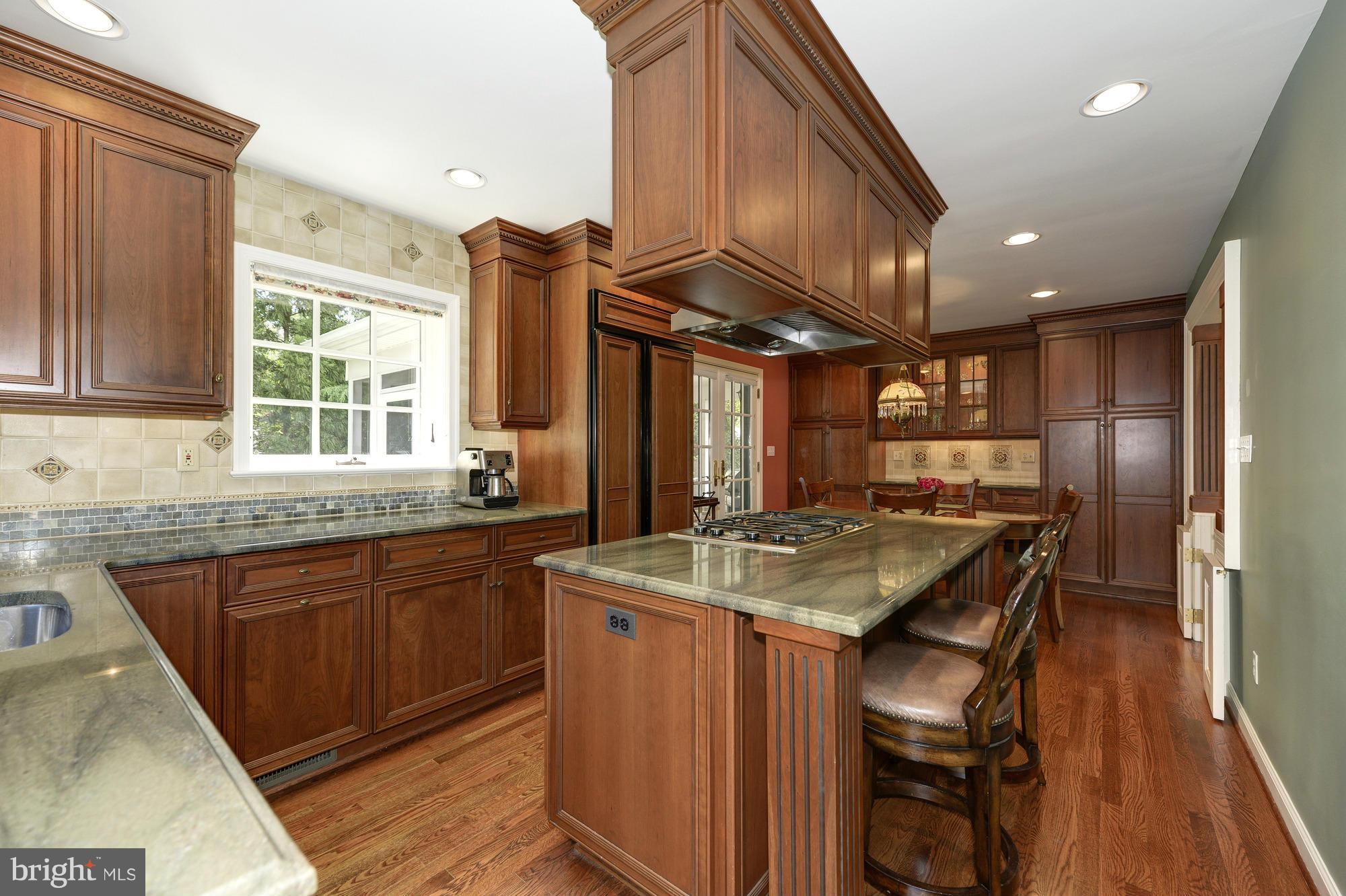 6752 Little Falls Road Arlington, VA 22213 - Photo 7 of 30 a kitchen with stainless steel appliances granite countertop a sink a stove and a refrigerator