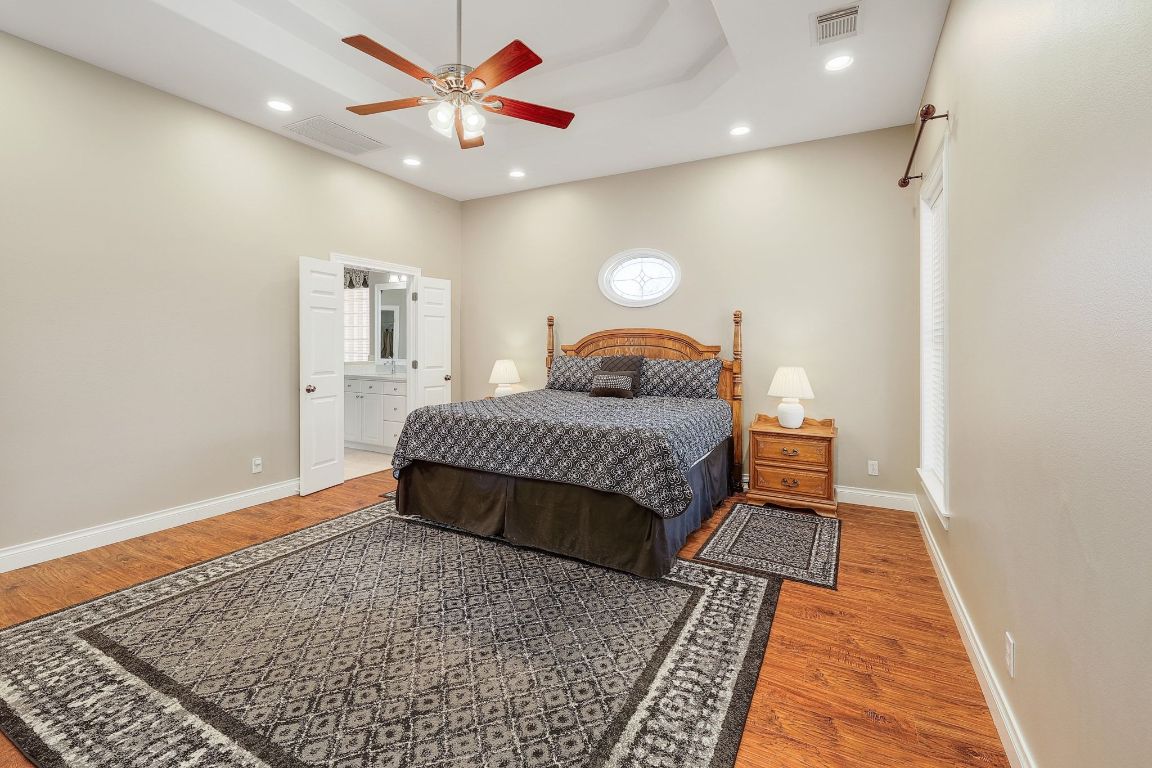 200 High River Ranch Drive Liberty Hill, TX 78642 - Photo 13 of 39 a bedroom with a bed and wooden floor