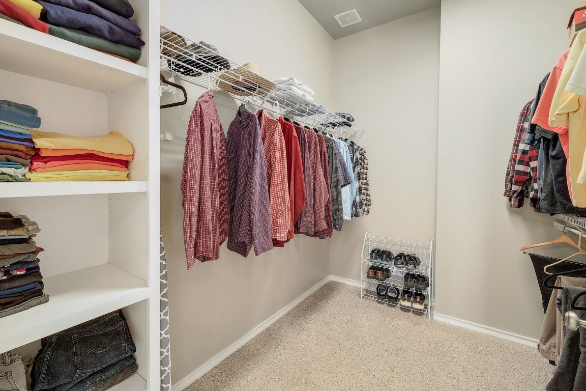 200 High River Ranch Drive Liberty Hill, TX 78642 - Photo 18 of 39 a view of walk in closet with clothes and shoes