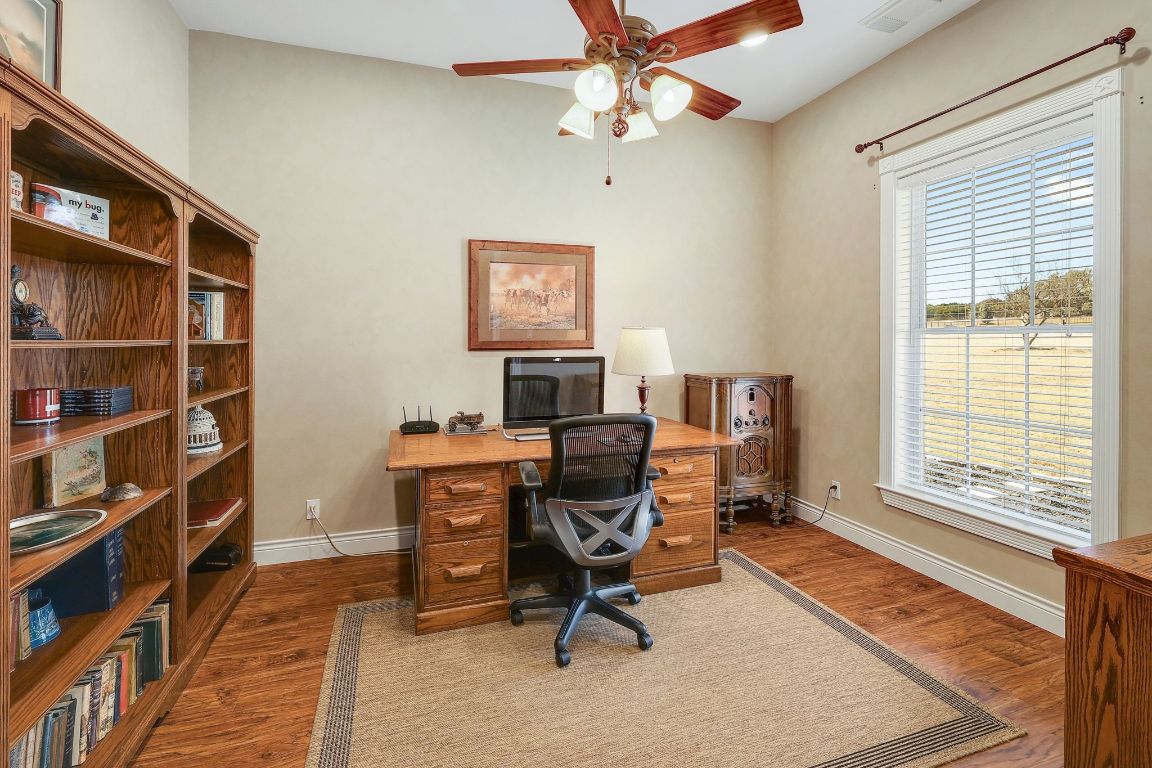 200 High River Ranch Drive Liberty Hill, TX 78642 - Photo 19 of 39 a view of a workspace with furniture and a window