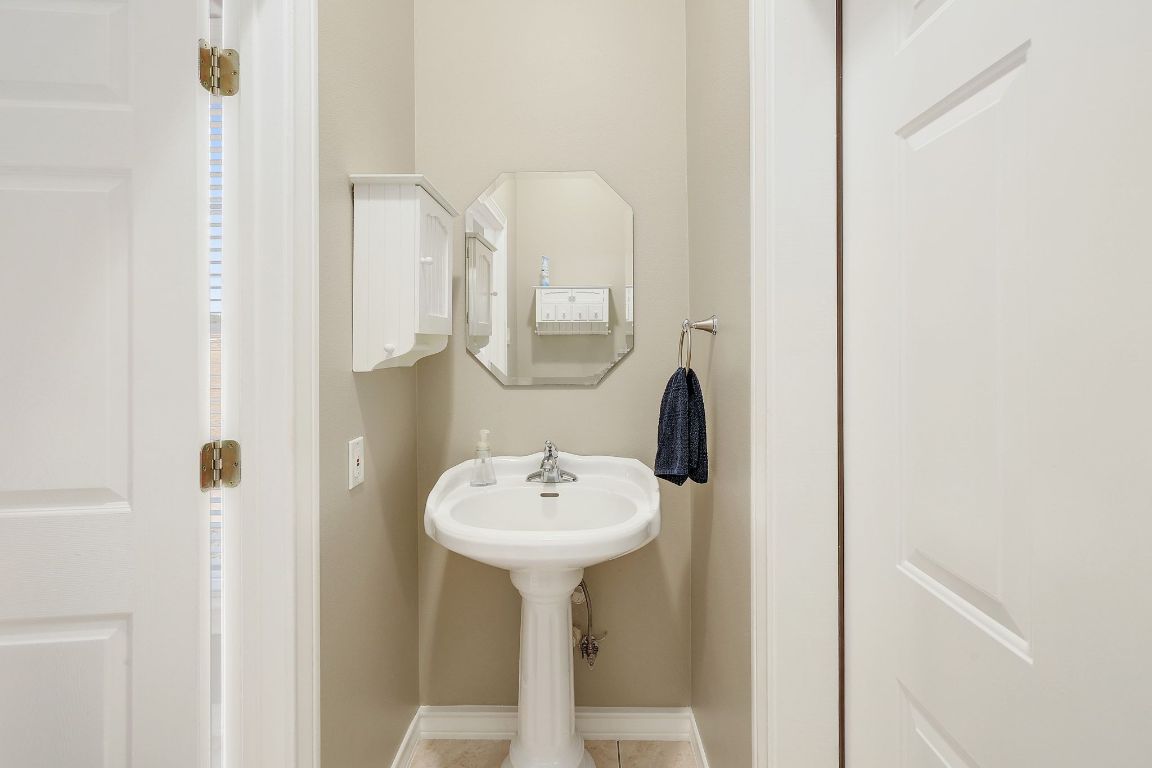 200 High River Ranch Drive Liberty Hill, TX 78642 - Photo 24 of 39 a bathroom with a sink and a mirror