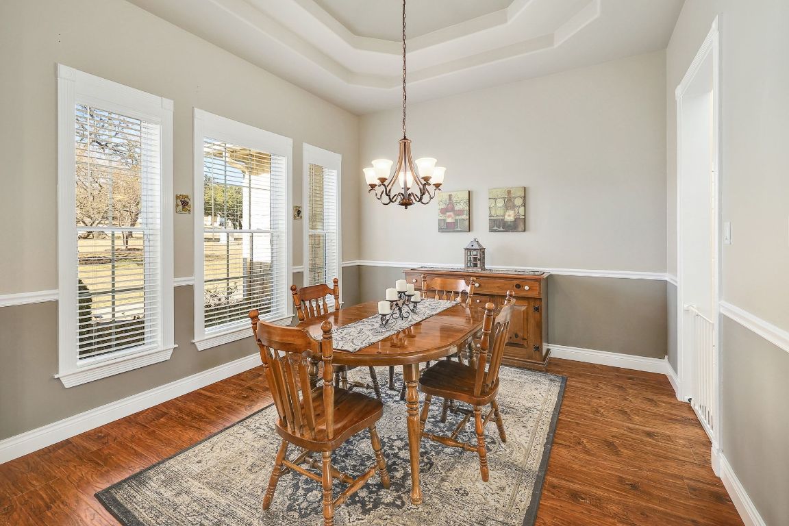 200 High River Ranch Drive Liberty Hill, TX 78642 - Photo 6 of 39 a view of a dining room with furniture window and wooden floor