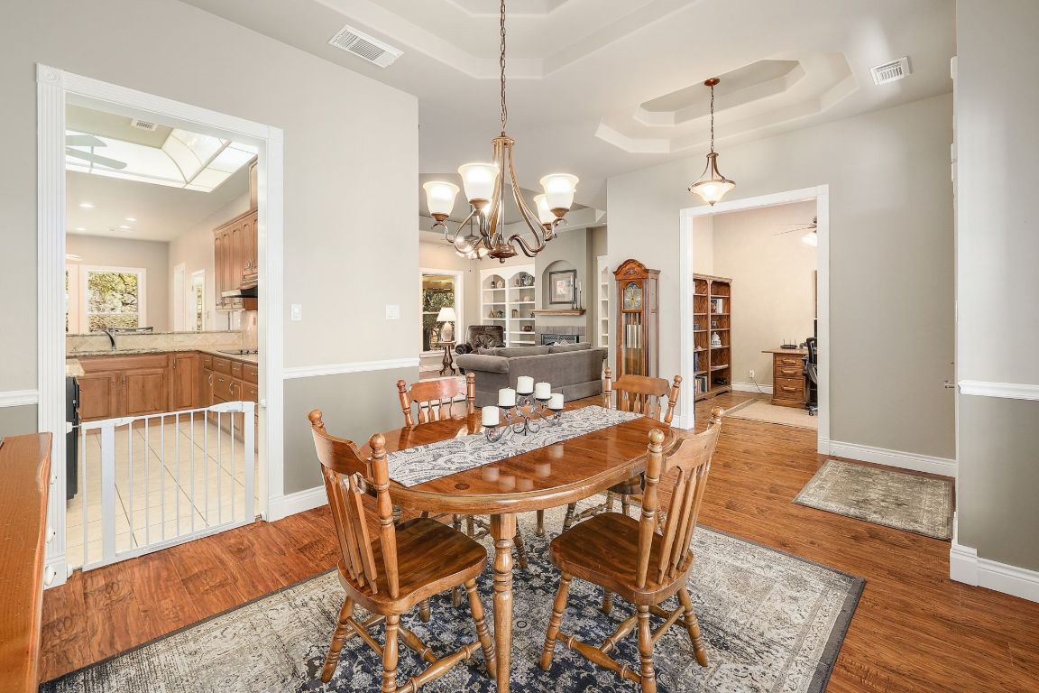 200 High River Ranch Drive Liberty Hill, TX 78642 - Photo 7 of 39 a view of a dining room with furniture and wooden floor